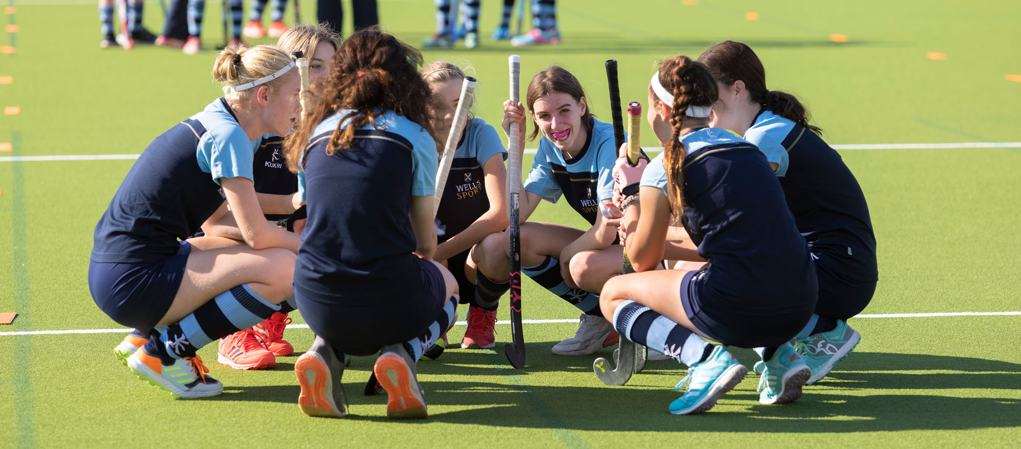 Senior School Girls Hockey Team in a huddle